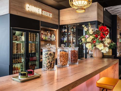 a counter with four jars of food on it at Mercure Paris Gare De Lyon TGV in Paris