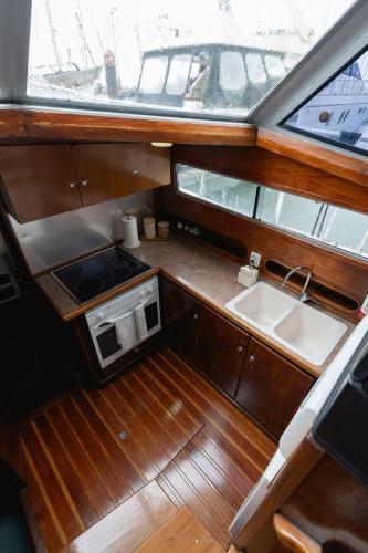 a small kitchen with a sink and a stove at Classic Seadream Yacht in Figueira da Foz