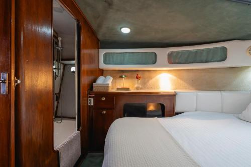 a bedroom with a bed and a desk in a boat at Classic Seadream Yacht in Figueira da Foz