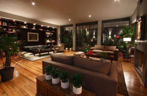 a large living room with couches and plants at Legado Mitico Buenos Aires in Buenos Aires