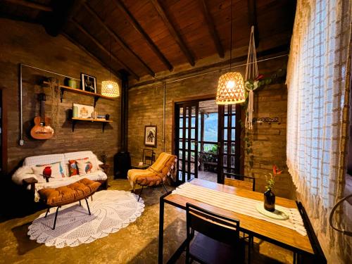 a living room with a bed and a table at Sítio Passarim in São Francisco Xavier