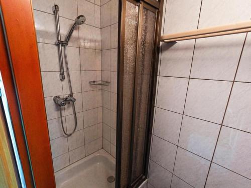 a bathroom with a shower with a tub at Almhütte Seebergalm in Seewiesen