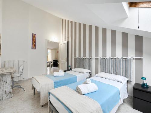 a bedroom with two beds and a fireplace at Cà di Lilly - Attic Suite AC Wi-Fi in Vado Ligure