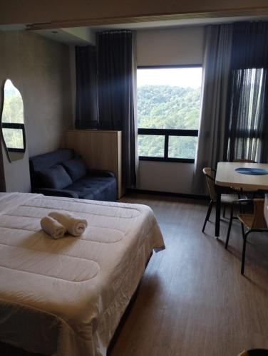 a hotel room with a bed and a couch at Sky Design Alphaville Hotel Residence in Barueri