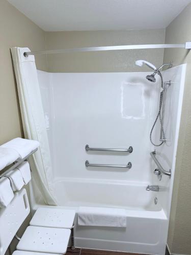 a bathroom with a shower and a toilet with towels at Super 8 by Wyndham Fond Du Lac in Fond du Lac