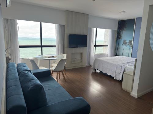 a living room with a couch and a bed at Flat Recife - Boa Viagem in Recife