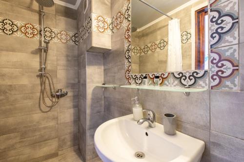 a bathroom with a sink and a mirror at Erofili Rooms in Agia Galini