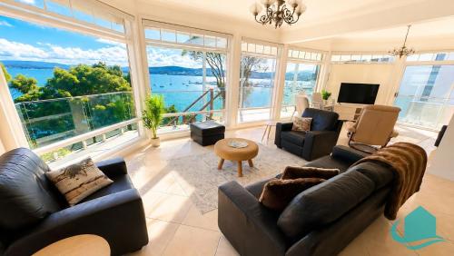 a living room filled with furniture and a large window at Azure Vista in Belmont