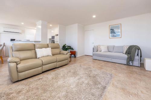 a living room with two couches and a couch at Beach Street Oasis - Tuncurry in Tuncurry