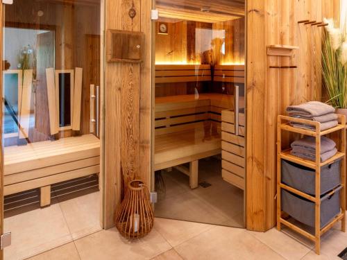 a bathroom with a shower with wooden walls at Spacious suite for 8 guests with a private sauna in Rauris