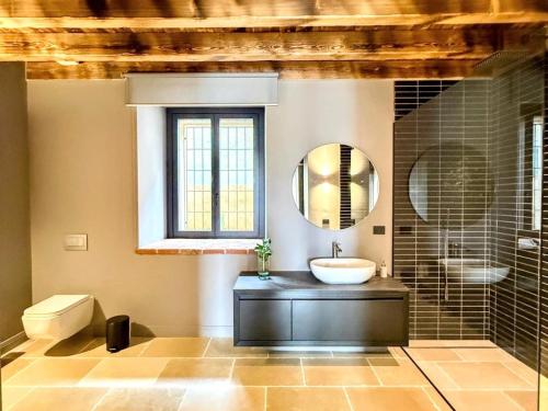 a bathroom with a sink and a mirror at Elegant suite with shared pool in Adro
