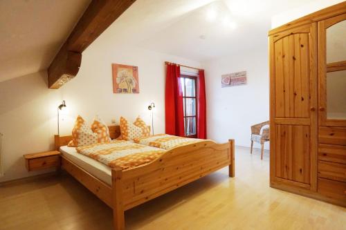 a bedroom with a wooden bed in a room at Paulhuberhof in Chieming