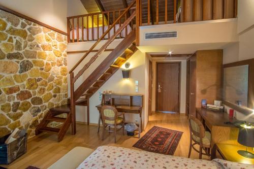 a room with a staircase and a living room at Orizontes Tzoumerkon Hotel Resort in Pramanta