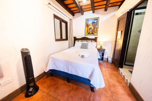 a bedroom with a bed in a room at Los Faroles Hotel & Spa in Antigua Guatemala