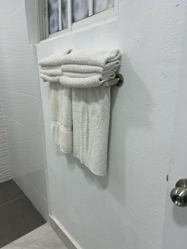 a bunch of towels are hanging on a door at Hannabi Beach Hotel in Boca Chica