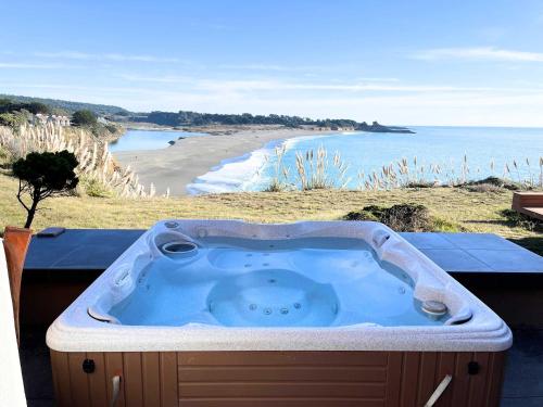 a hot tub with a view of a beach at Pacific Bliss Haven in Gualala
