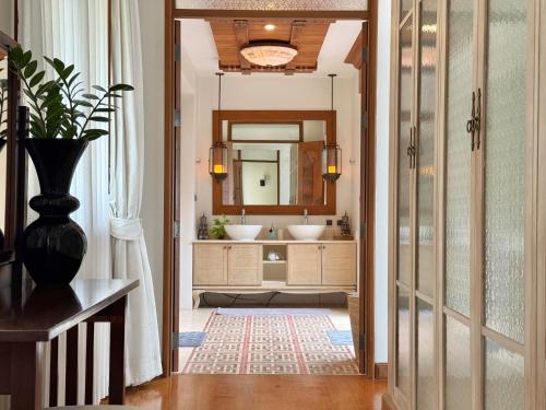 a bathroom with two sinks and a mirror at Royal Legacy Golf Private Villa in Rawai Beach