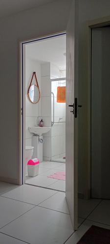 an open door to a bathroom with a sink at Apto aconchegante próximo à UFS in São Cristóvão