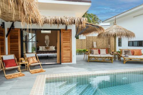 a villa with a swimming pool and a resort at Manao Pool Villa 6 - 5 Mins Walk To The Beach in Ko Lanta