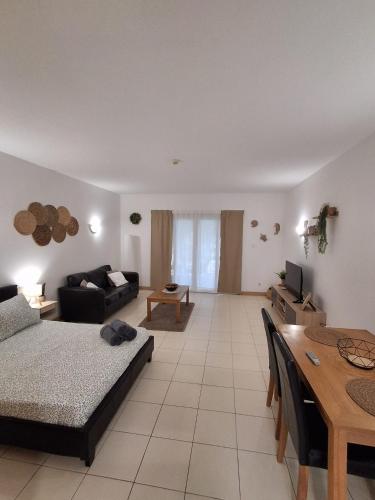 a large living room with a couch and a table at Vila Verde Sal Calistemon in Prainha