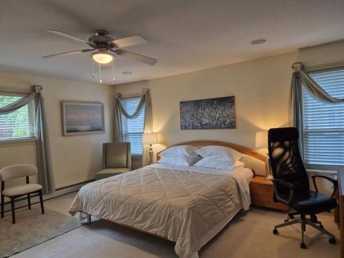 a bedroom with a bed and a ceiling fan at Solo Room-Meadow Ridge Haven in Maple Ridge