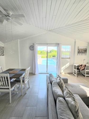 a living room with a couch and a table at Swan Cottages #5 Waterfront in Providenciales