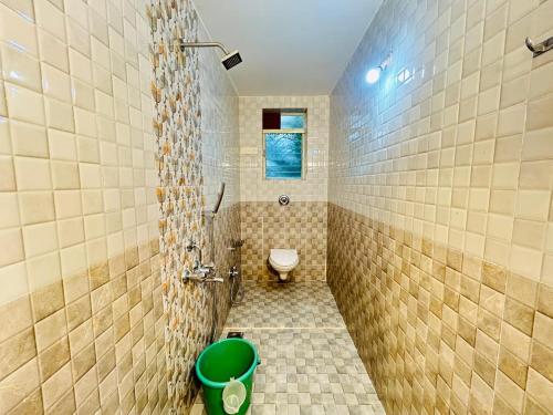 a bathroom with a shower with a toilet and a sink at Rajdeep by Dacha Arambol in Arambol