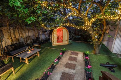 a backyard with a table and a tree with lights at Zen Haven with Sauna & Spa in Tootgarook