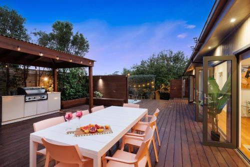 a patio with a white table and chairs at Zen Haven with Sauna & Spa in Tootgarook