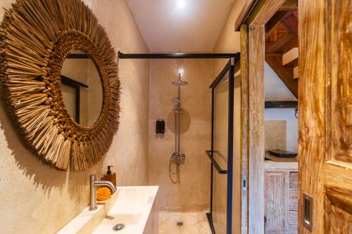a bathroom with a mirror and a shower at Misane Serenity in Gianyar