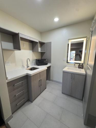 a small kitchen with a sink and a microwave at INN at King City in King City