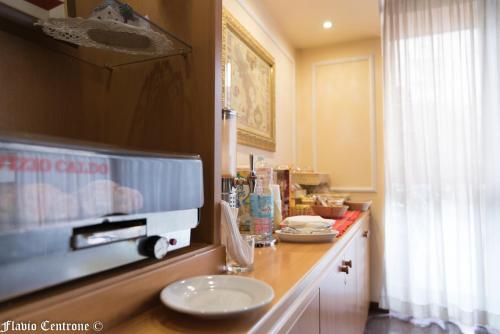 a kitchen with a counter top with a plate on it at Hotel Cristal in Bari