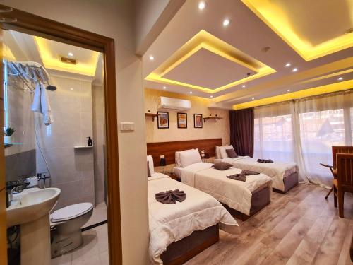 a hotel room with two beds and a bathroom at tourist hotel cairo downtown in Cairo