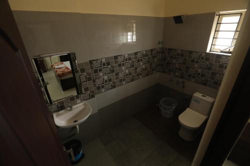 a small bathroom with a sink and a toilet at Classique Inn Near Padmanabhaswamy Temple in Trivandrum