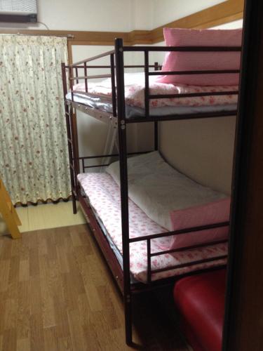 a couple of bunk beds in a room at Guest House Wa N Wa in Osaka