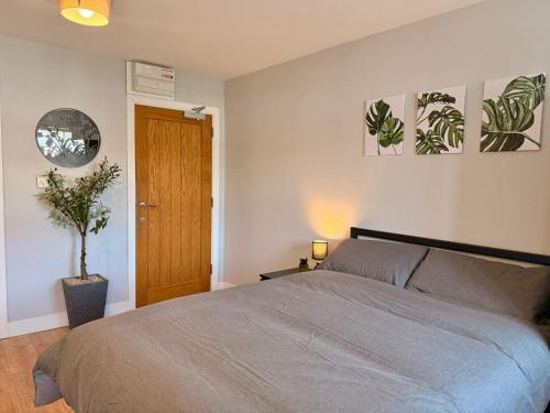 a bedroom with a bed and two pictures on the wall at Leatherhead Studios by WorkStay in Leatherhead
