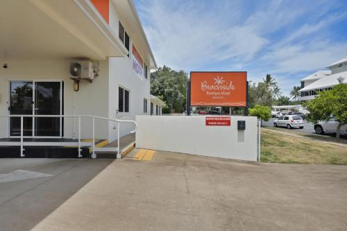 a building with a sign on the side of it at Beachside Boutique Motel Mackay in Mackay