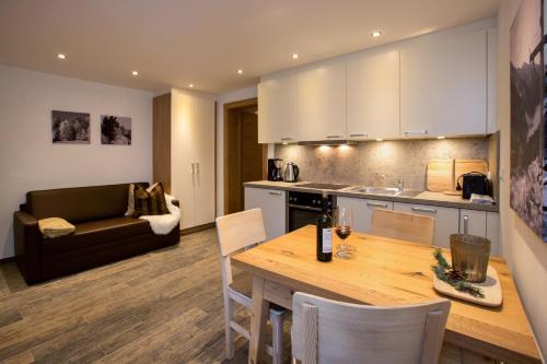 a kitchen and living room with a table and a couch at Apart Lutz in Prutz