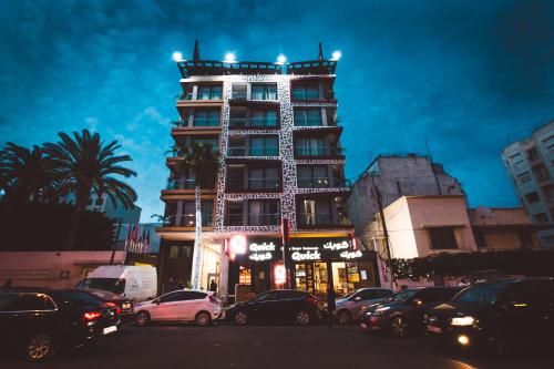 a tall building with cars parked in front of it at DownTown Hotel By New Art in Casablanca