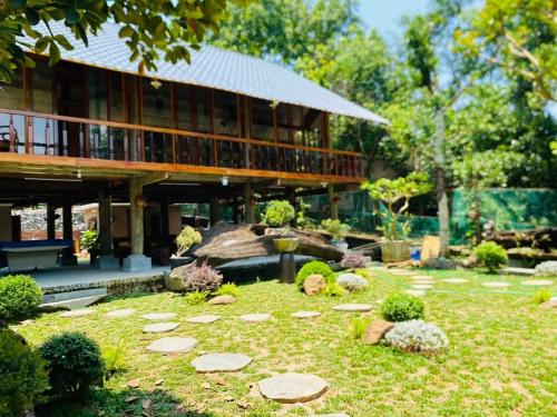 a garden with rocks in front of a building at Homestay-pickleball in Ðồng Vo