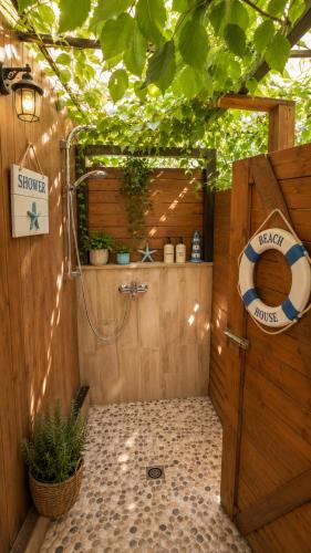 a bathroom with a shower with a sign on it at Happy House in Kranevo