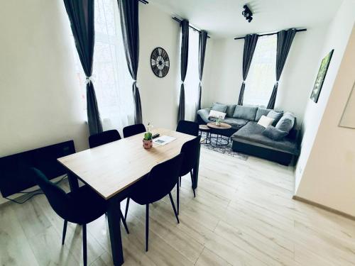 a living room with a table and chairs and a couch at Apartmány 68 in Kámen