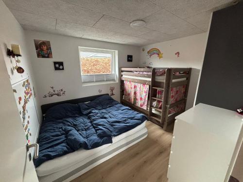 a small bedroom with a bed and a crib at Villa EVchargeFree in Horsens