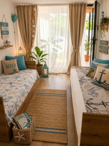 a bedroom with two beds and a window at Casa M in Kranevo