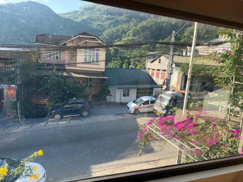 a view from a window of a street with cars at Sơn Trang House in Sapa