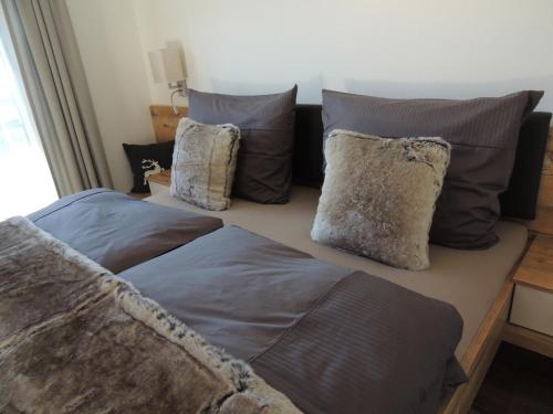 a bedroom with two beds and pillows at Apart Gaberhof in Tarrenz
