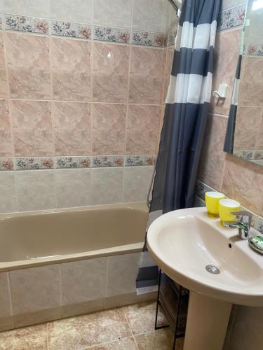 a bathroom with a sink and a tub at Voulez Vous in Lo Pagán