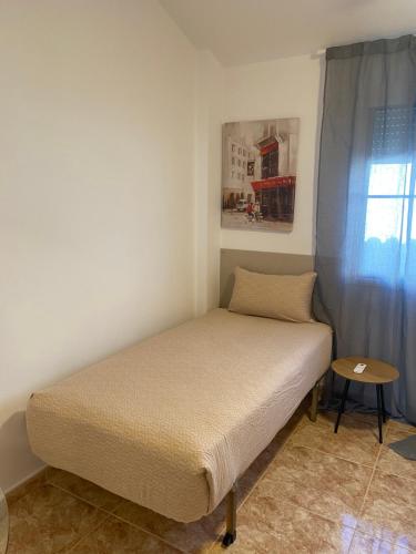 a small bed in a room with a window at Voulez Vous in Lo Pagán
