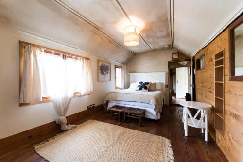 a bedroom with a bed and a table and a window at Mrs Banks in Robe