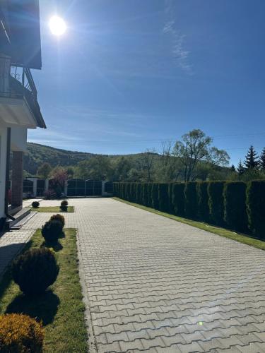 a stone walkway in front of a house at Casa Tică in Vama Buzăului